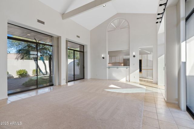 a view of a kitchen with a refrigerator and a sink