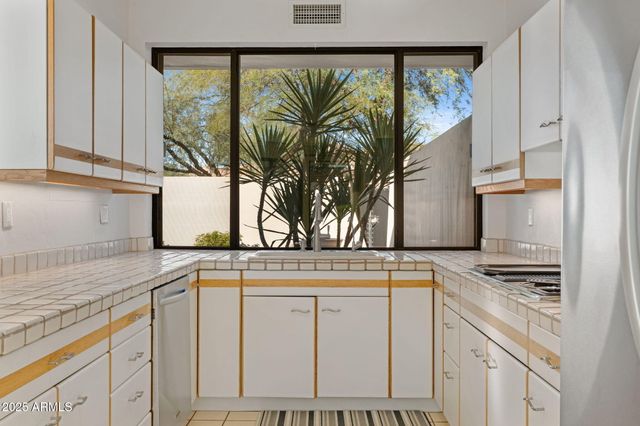 a kitchen with stainless steel appliances a cabinets and a stove top oven
