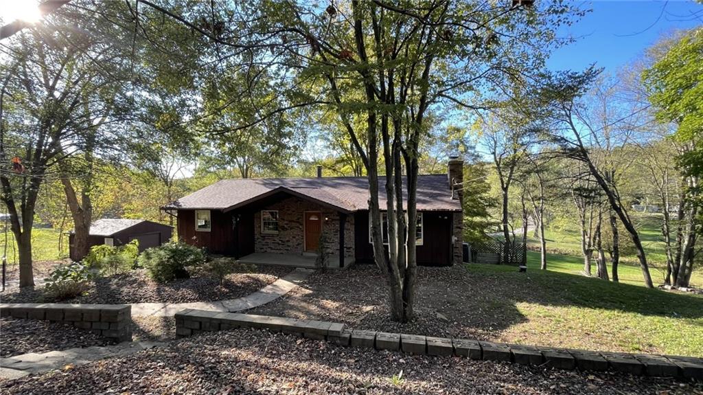 303 Elkhorn Road Monaca, PA 15061 - Photo 2 of 19 a front view of a house with garden