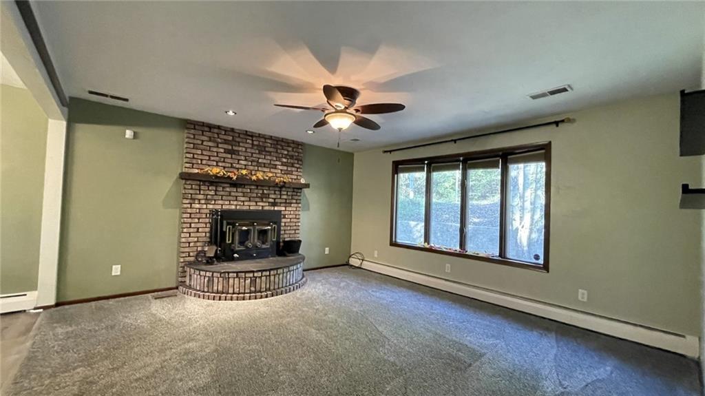 303 Elkhorn Road Monaca, PA 15061 - Photo 3 of 19 an empty room with fireplace and windows