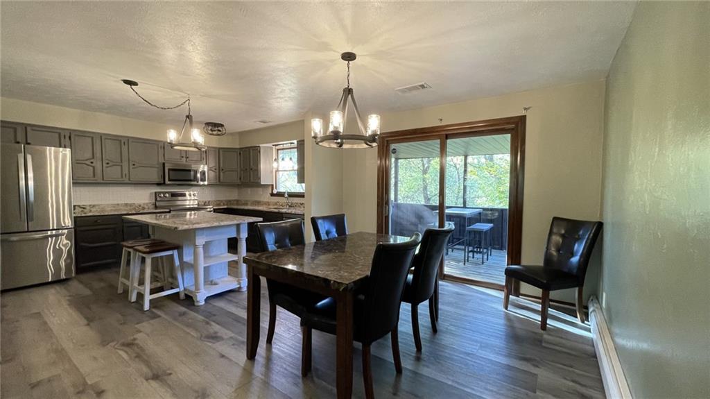 303 Elkhorn Road Monaca, PA 15061 - Photo 5 of 19 a view of a dining room with furniture window and wooden floor