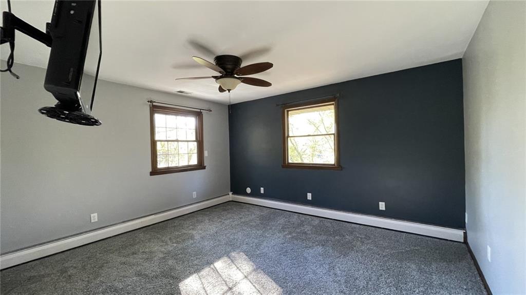 303 Elkhorn Road Monaca, PA 15061 - Photo 7 of 19 an empty room with windows and fan