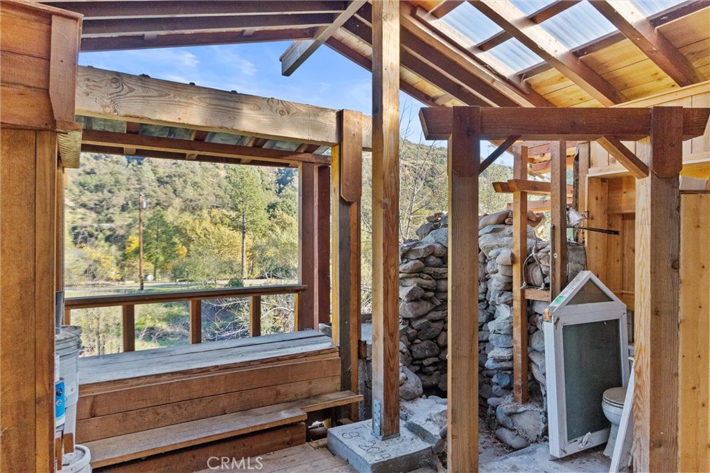 12656 Centerville Road Chico, CA 95928 - Photo 27 of 45 Cabin Interior has Picture Window of Bluff and Creek Area. Note Rock Shower and Conventional Toilet at Right
l