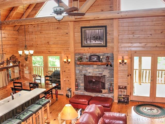 170 River Hills Road Lansing, NC 28643 - Photo 8 of 44 a living room with furniture a fireplace and next to a window