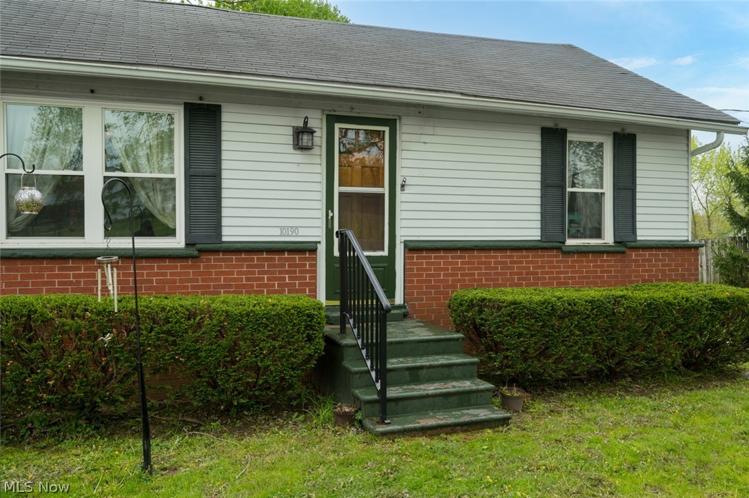 10190 Penniman Road Orwell, OH 44076 - Photo 16 of 24 Exterior facade featuring white horizontal siding and a red brick foundation