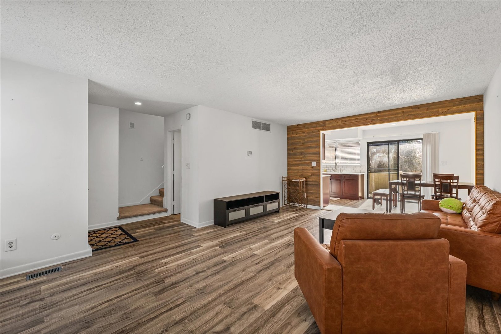 20 Colony W Drive Champaign, IL 61820 - Photo 7 of 26 a living room with furniture a large window wooden floor and a fireplace