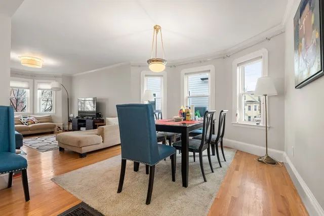 a view of a dining room with furniture window and wooden floor