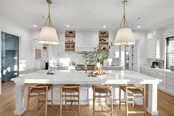 a dining table with chairs and kitchen chandelier