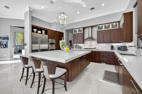 a bedroom with two beds and a chandelier