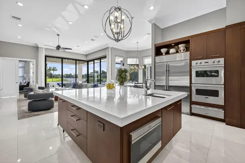 a living room with furniture wooden floor and a large window