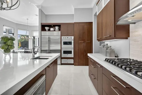 a view of a house with a swimming pool and a porch with furniture