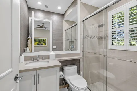 a living room with fireplace furniture and a large window