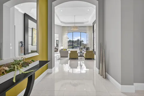a living room with furniture large window and flat screen tv