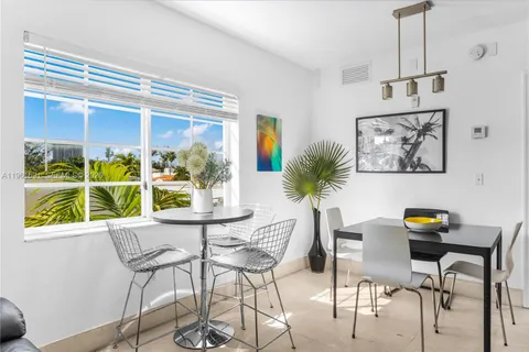 a dining room with furniture and window
