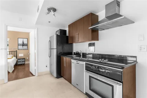a kitchen with stainless steel appliances a sink dishwasher and a refrigerator