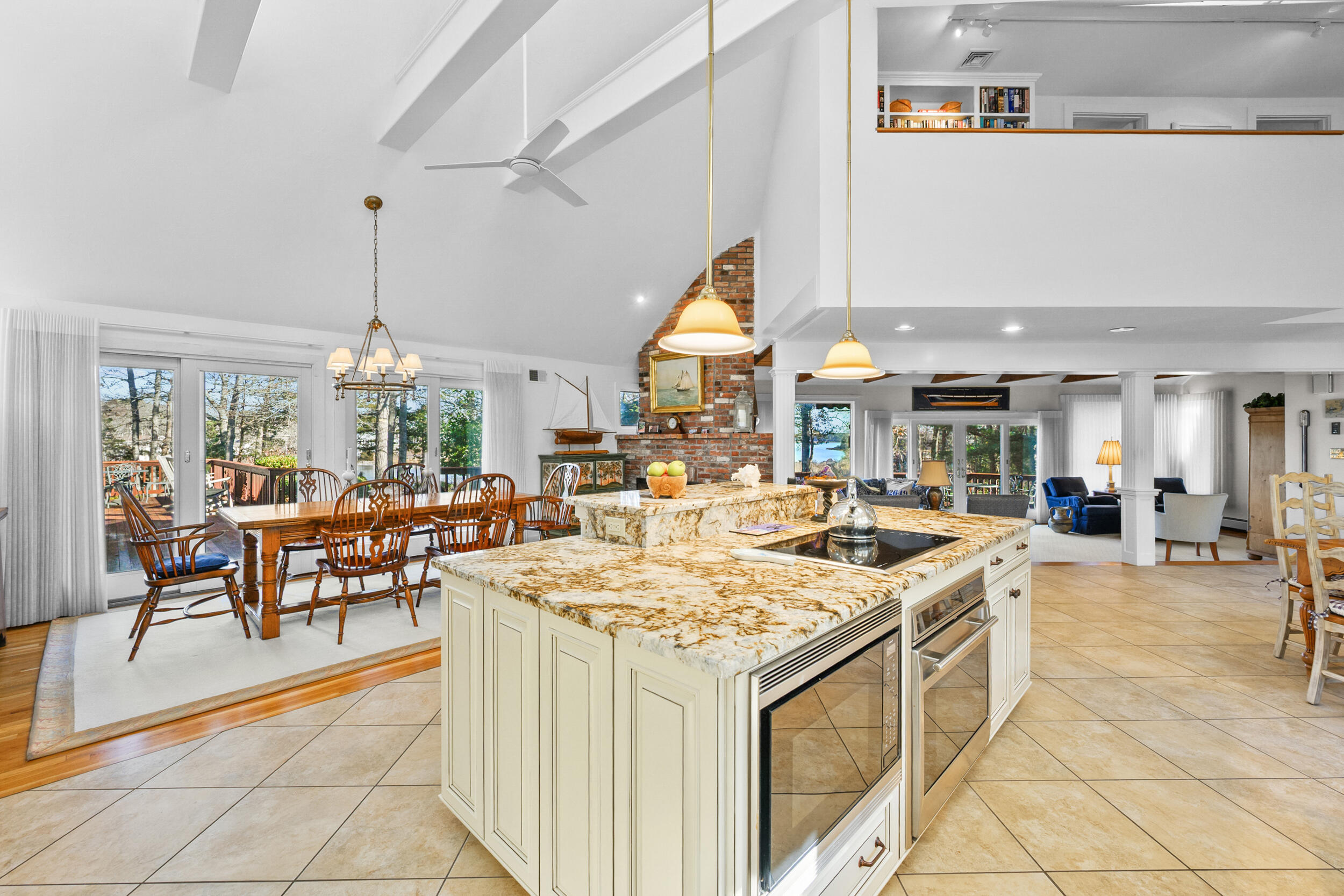 52 Old Dock Lane Mashpee, MA 02649 - Photo 14 of 56 a view of a kitchen with kitchen island stainless steel appliances a table and chairs in it