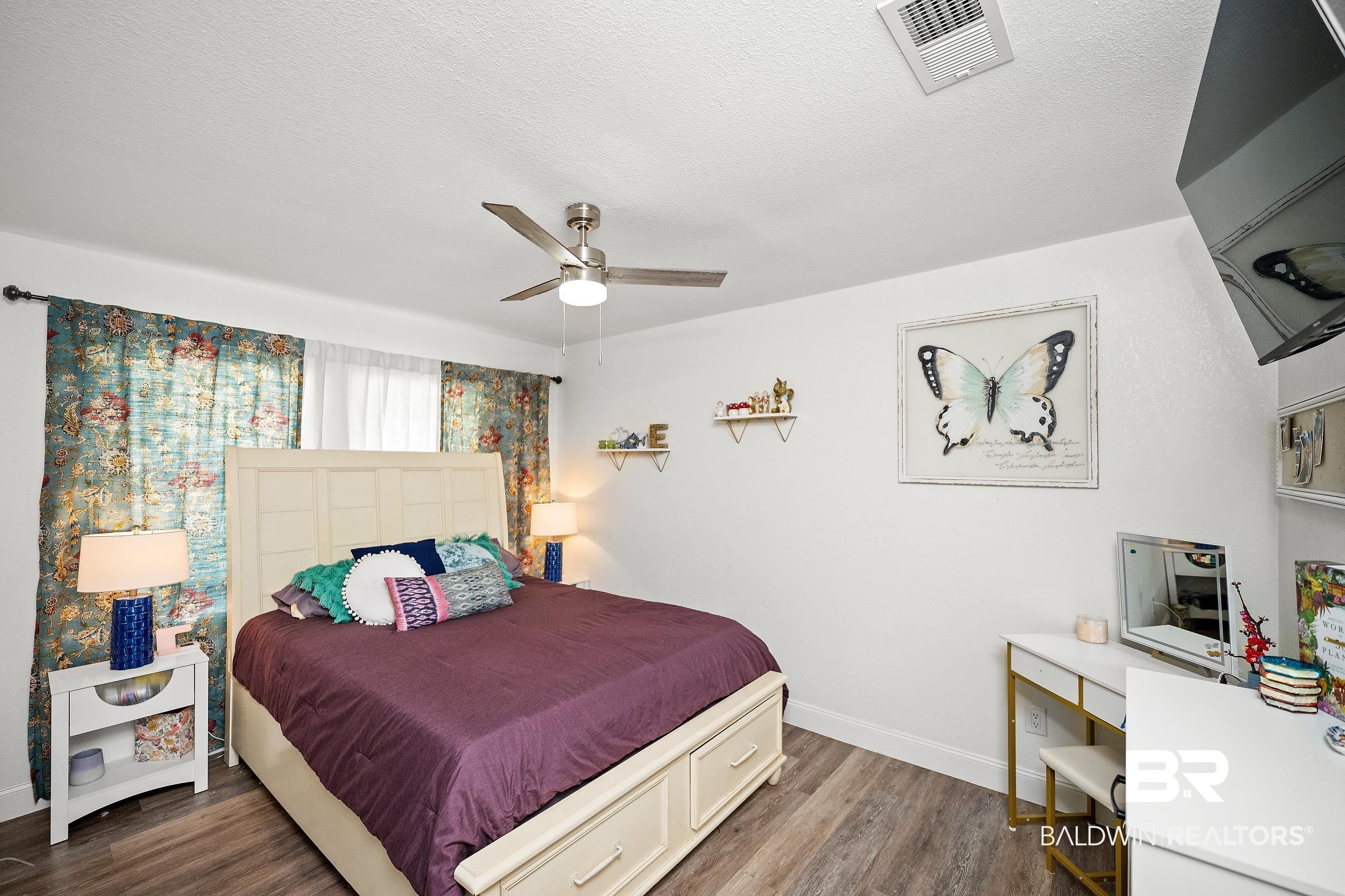 33129 Antietam Road Lillian, AL 36549 - Photo 19 of 31 Bedroom featuring wood-finish flooring, a ceiling fan with integrated lighting, and white walls