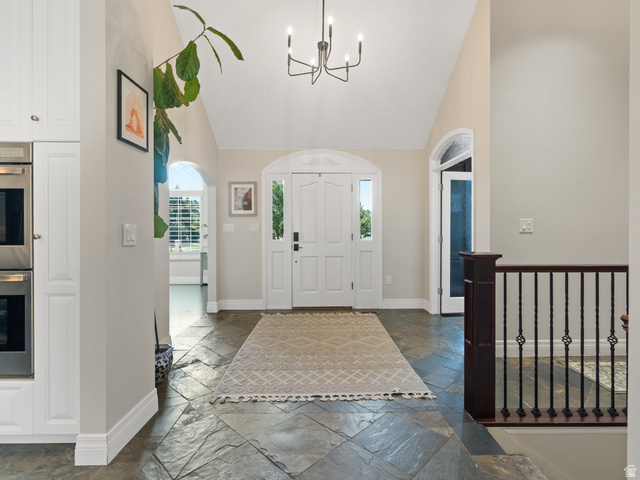 13357 Trail Rider Circle Draper, UT 84020 - Photo 2 of 70 Vaulted entryway featuring slate tile flooring and a decorative chandelier