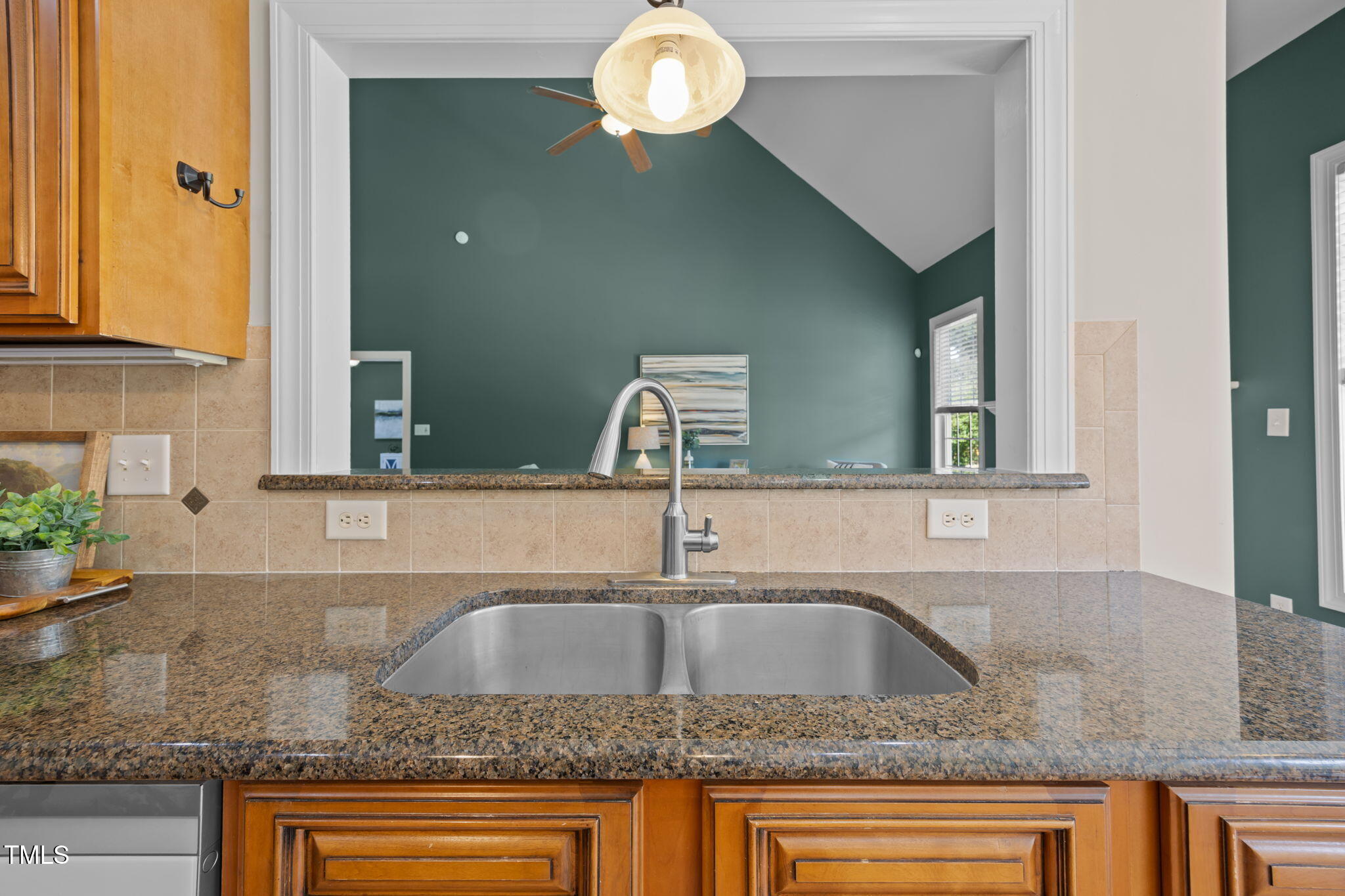 6313 Southern Charm Lane Raleigh, NC 27603 - Photo 14 of 38 a kitchen with kitchen island granite countertop a sink and a cabinets
