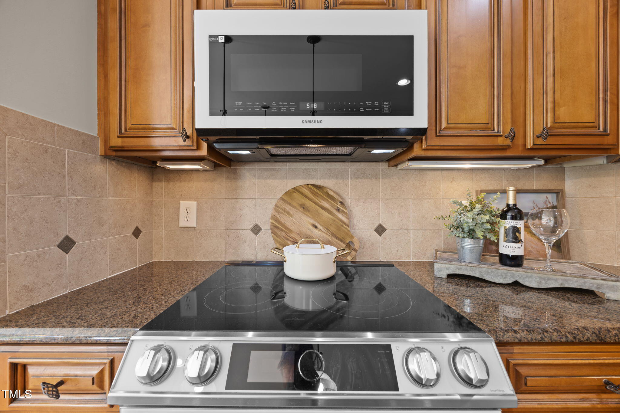 6313 Southern Charm Lane Raleigh, NC 27603 - Photo 16 of 38 a kitchen with a stove and a microwave