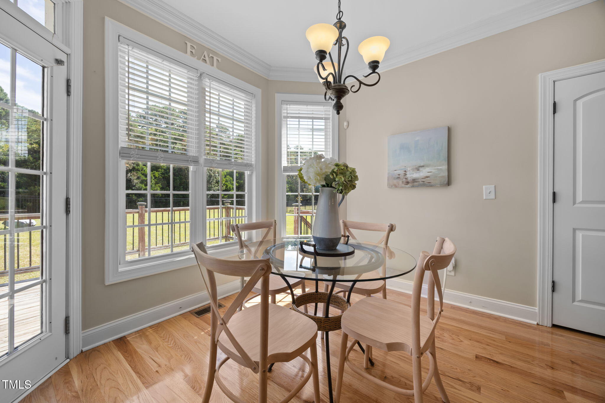 6313 Southern Charm Lane Raleigh, NC 27603 - Photo 18 of 38 a view of a dining room with furniture wooden floor and chandelier