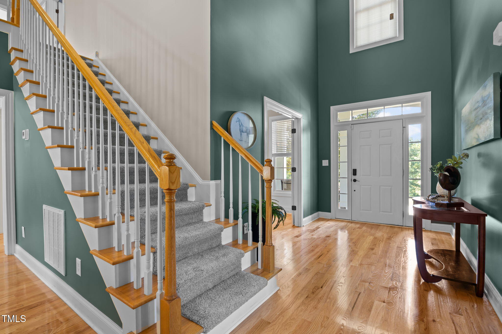 6313 Southern Charm Lane Raleigh, NC 27603 - Photo 25 of 38 a view of a hallway with wooden floor and staircase