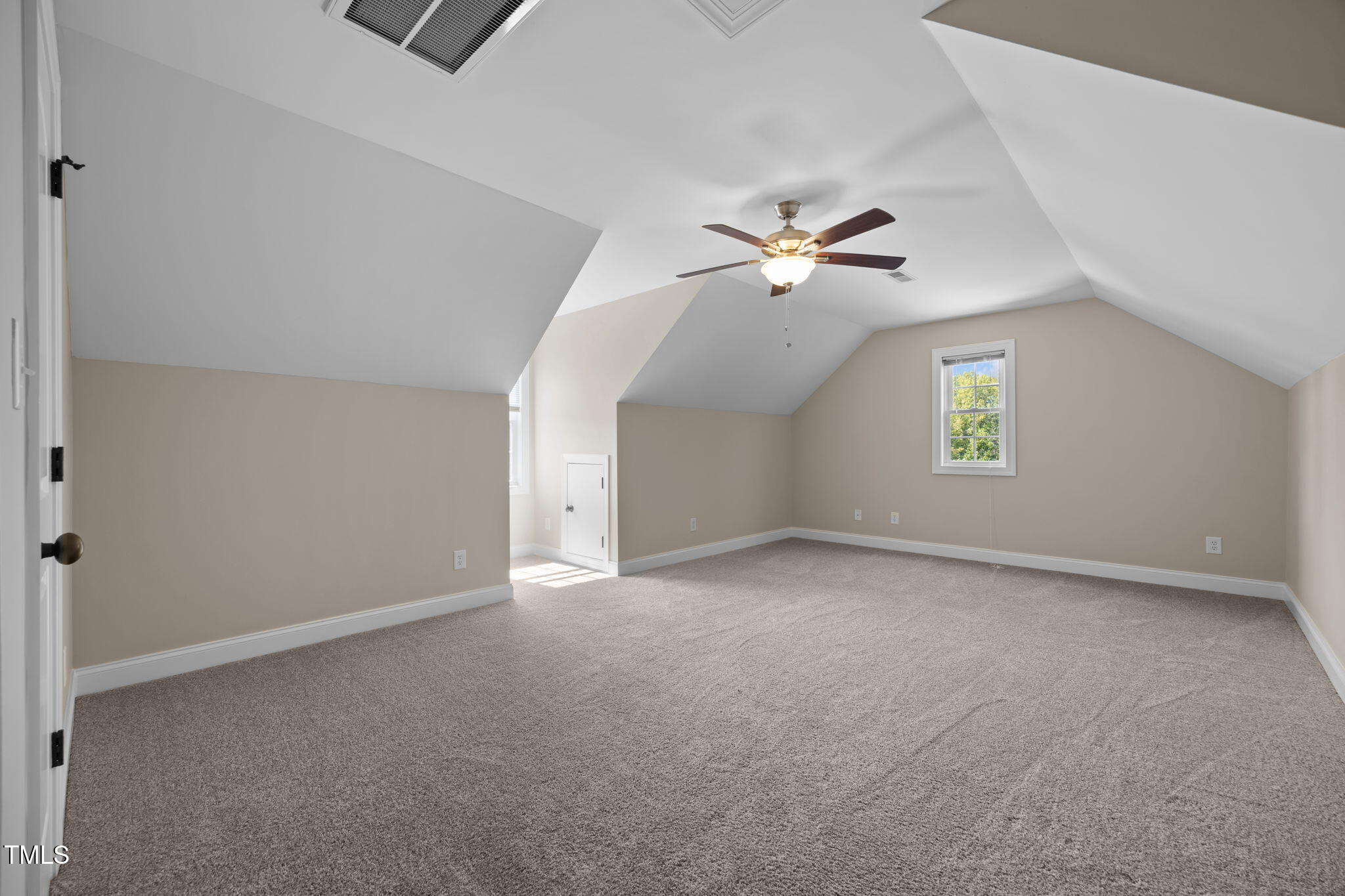 6313 Southern Charm Lane Raleigh, NC 27603 - Photo 26 of 38 an empty room with a window and a fan