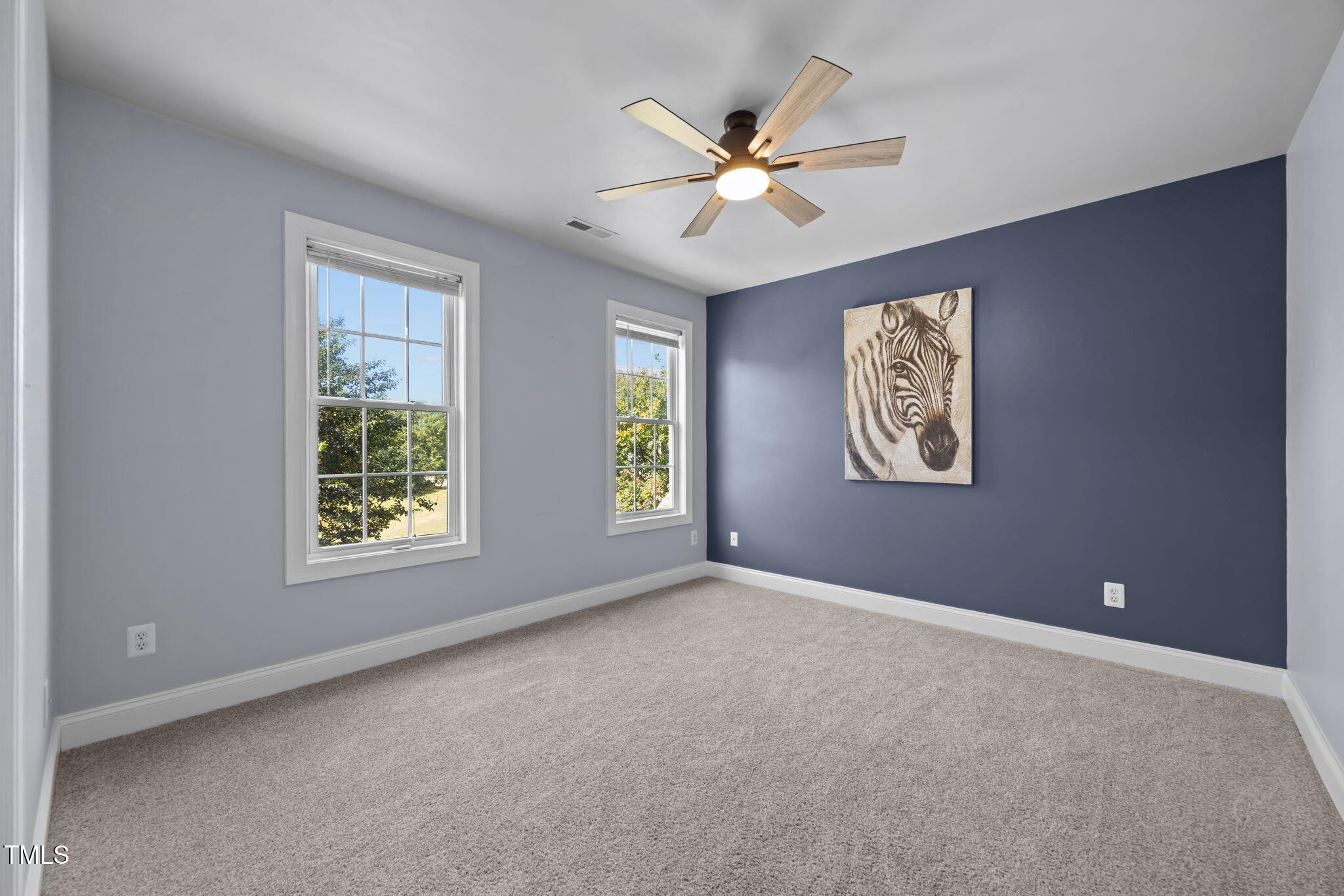 6313 Southern Charm Lane Raleigh, NC 27603 - Photo 28 of 38 an empty room with windows and fan