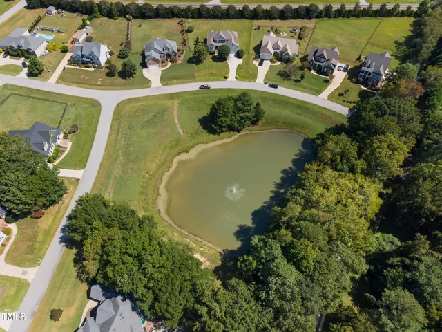 an aerial view of a house with a lake view