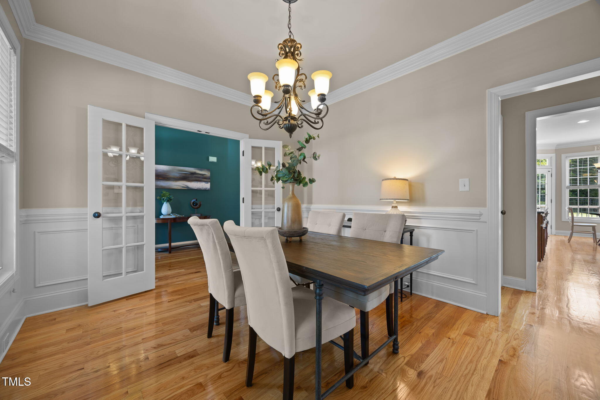 6313 Southern Charm Lane Raleigh, NC 27603 - Photo 10 of 38 a view of a dining room with furniture wooden floor and chandelier