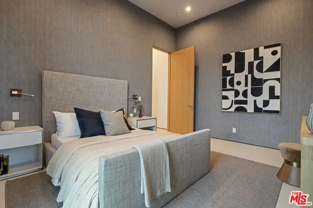 a spacious bedroom with a bed and a large window