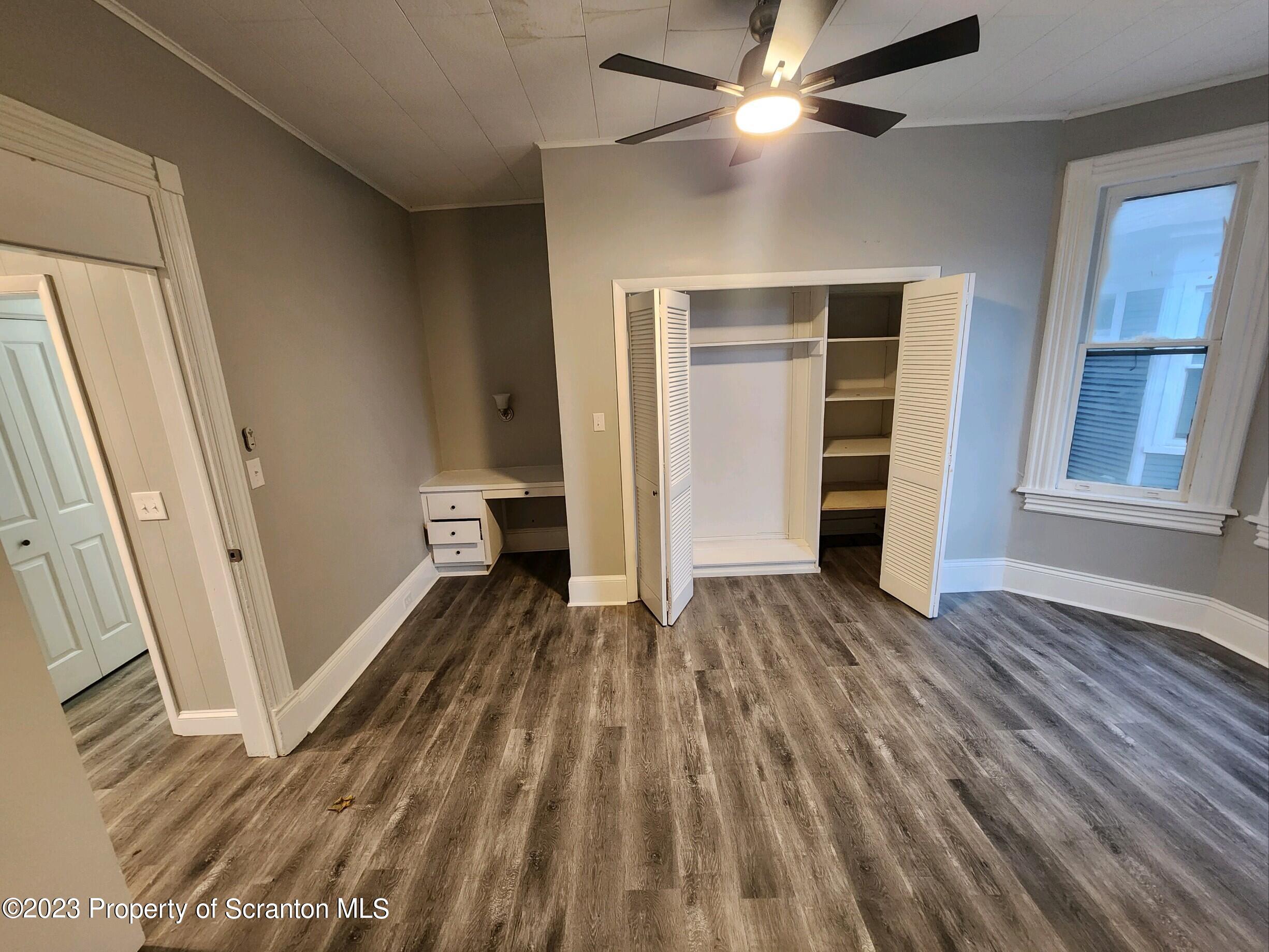 817 Monroe Avenue, Unit 1 Scranton, PA 18510 - Photo 4 of 8 wooden floor in an empty room with a fireplace