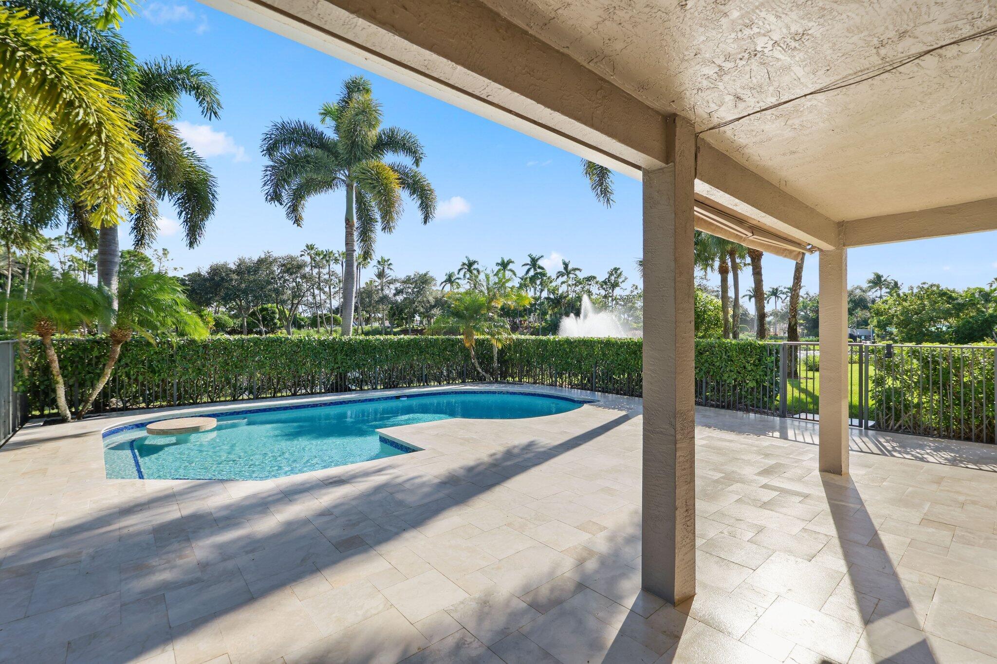 19245 Skyridge Circle Boca Raton, FL 33498 - Photo 32 of 70 a view of a house with a swimming pool and a yard