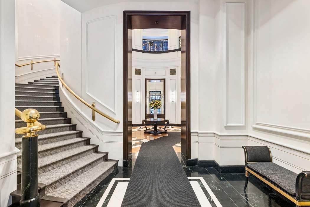 120 East 87th Street, Unit R14K Manhattan, NY 10128 - Photo 11 of 14 a view of a hallway with wooden floor and staircase