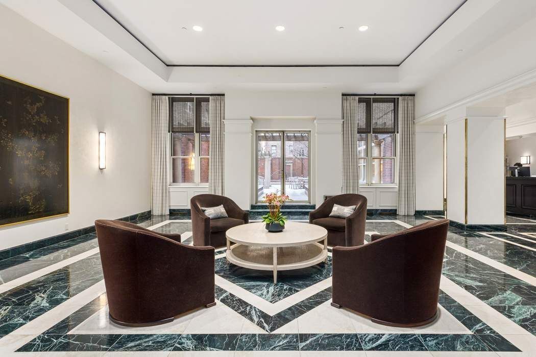 120 East 87th Street, Unit R14K Manhattan, NY 10128 - Photo 12 of 14 a living room with furniture and wooden floor