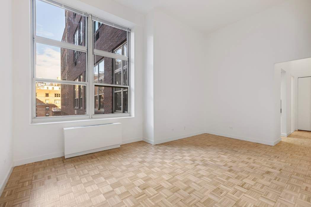 120 East 87th Street, Unit R14K Manhattan, NY 10128 - Photo 5 of 14 a view of an empty room with chandelier fan and fire place