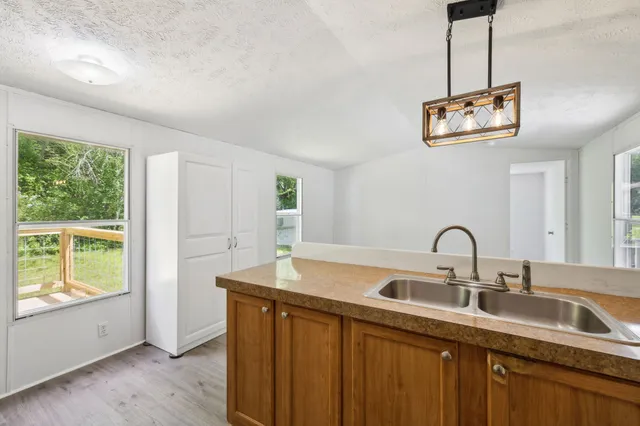 a kitchen with a sink and a large window
