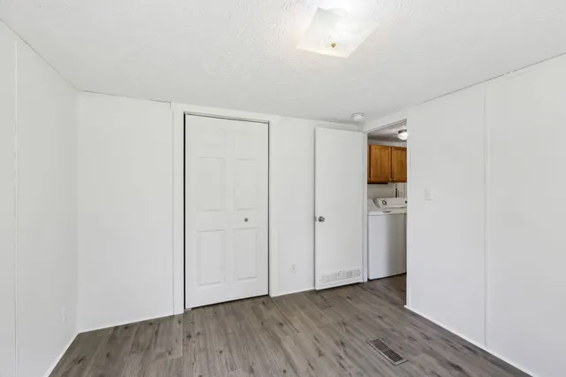 a view of hallway with wooden floor
