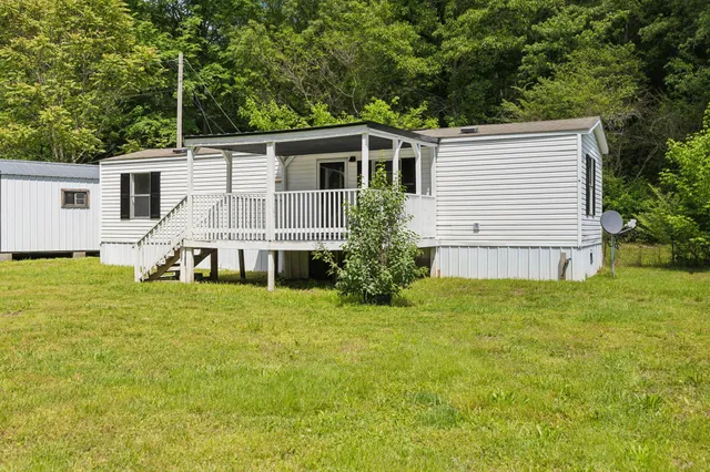 a front view of house with yard and green space