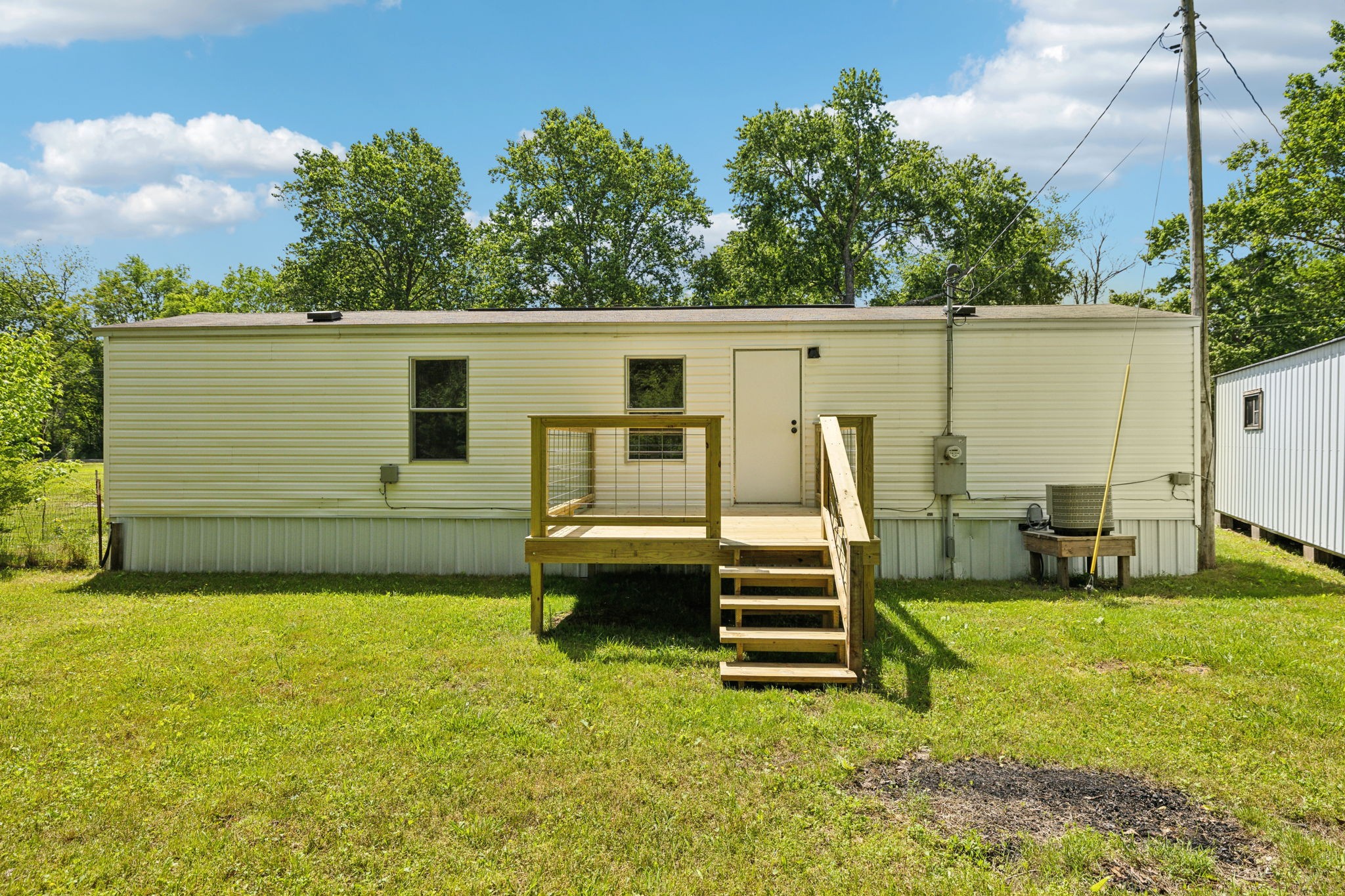 161 Longbranch Road Hohenwald, TN 38462 - Photo 24 of 28 a view of a backyard with sitting area
