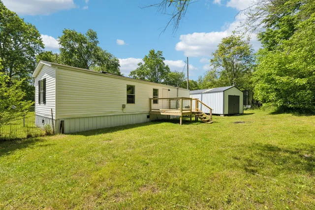 a view of a house with a yard