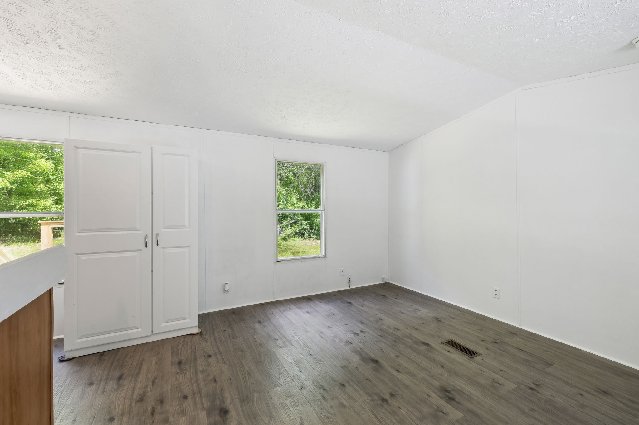 161 Longbranch Road Hohenwald, TN 38462 - Photo 6 of 28 an empty room with wooden floor and window