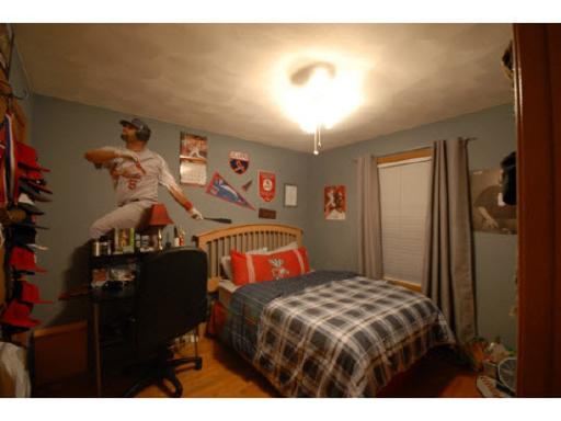 654 Bayfield Road Rockton, IL 61072 - Photo 10 of 11 a bedroom with a bed and a chandelier