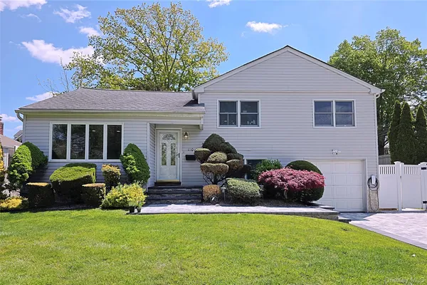 a front view of house with yard and outdoor seating