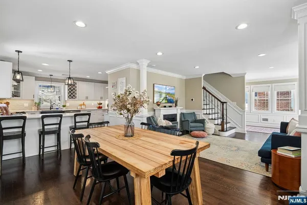 a dining room with furniture a kitchen and chandelier