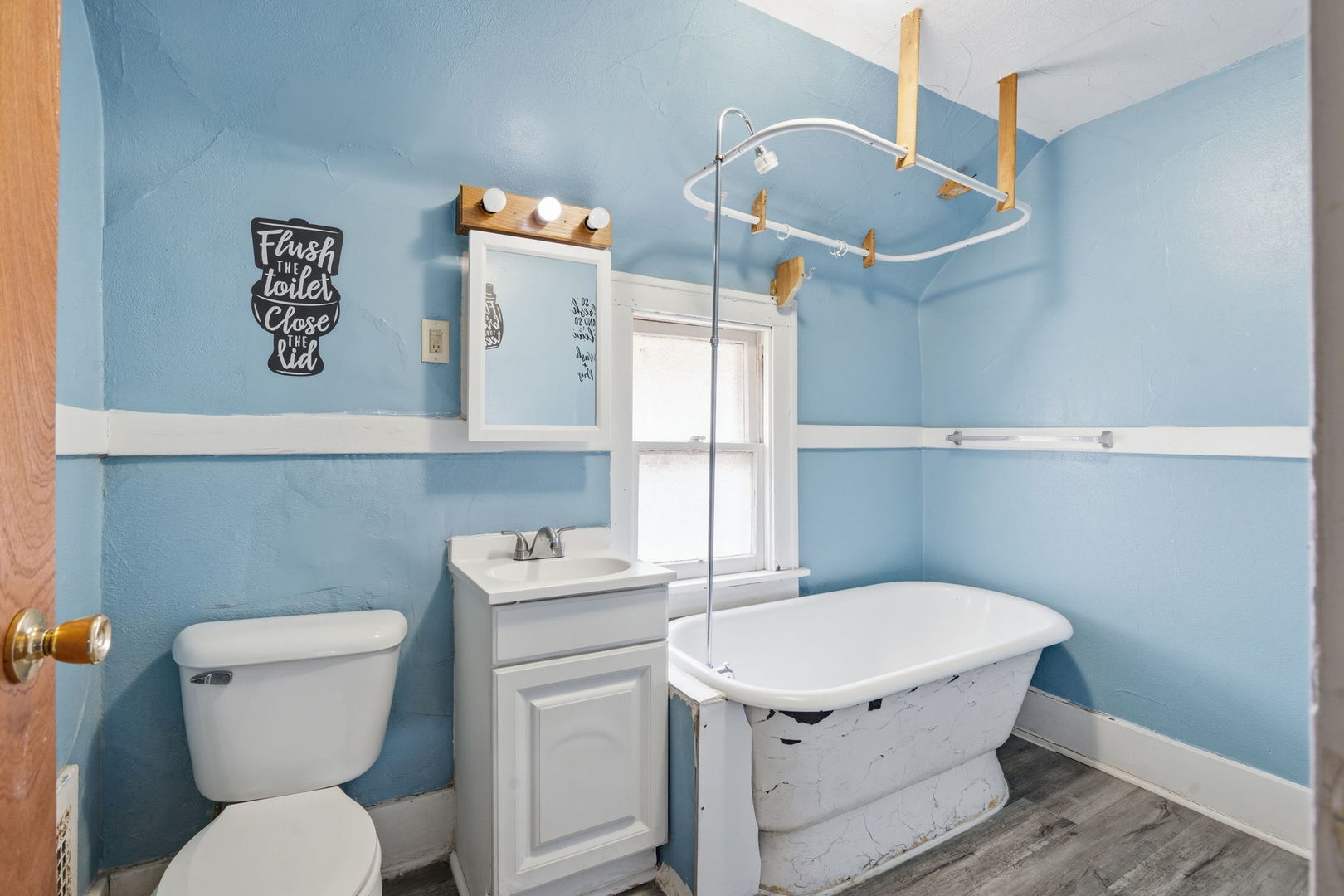 903 44th Street Rock Island, IL 61201 - Photo 18 of 28 a bathroom with a toilet a sink and a mirror