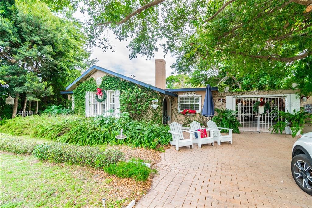 a front view of a house with porch and garden