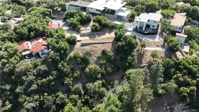 an aerial view of a house with a yard and garden