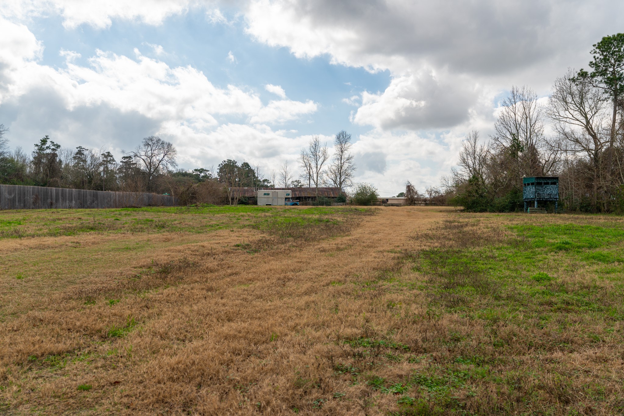 25503 Hufsmith Cemetery Road Tomball, TX 77375 - Photo 18 of 24 A natural access road runs through the heart of this 5.44-acre parcel, offering immediate vehicular access to the full depth of the property. Open fields flank both sides of the path, giving buyers a clear picture of the usable land available — and the incredible development opportunity this Tomball-area tract represents.