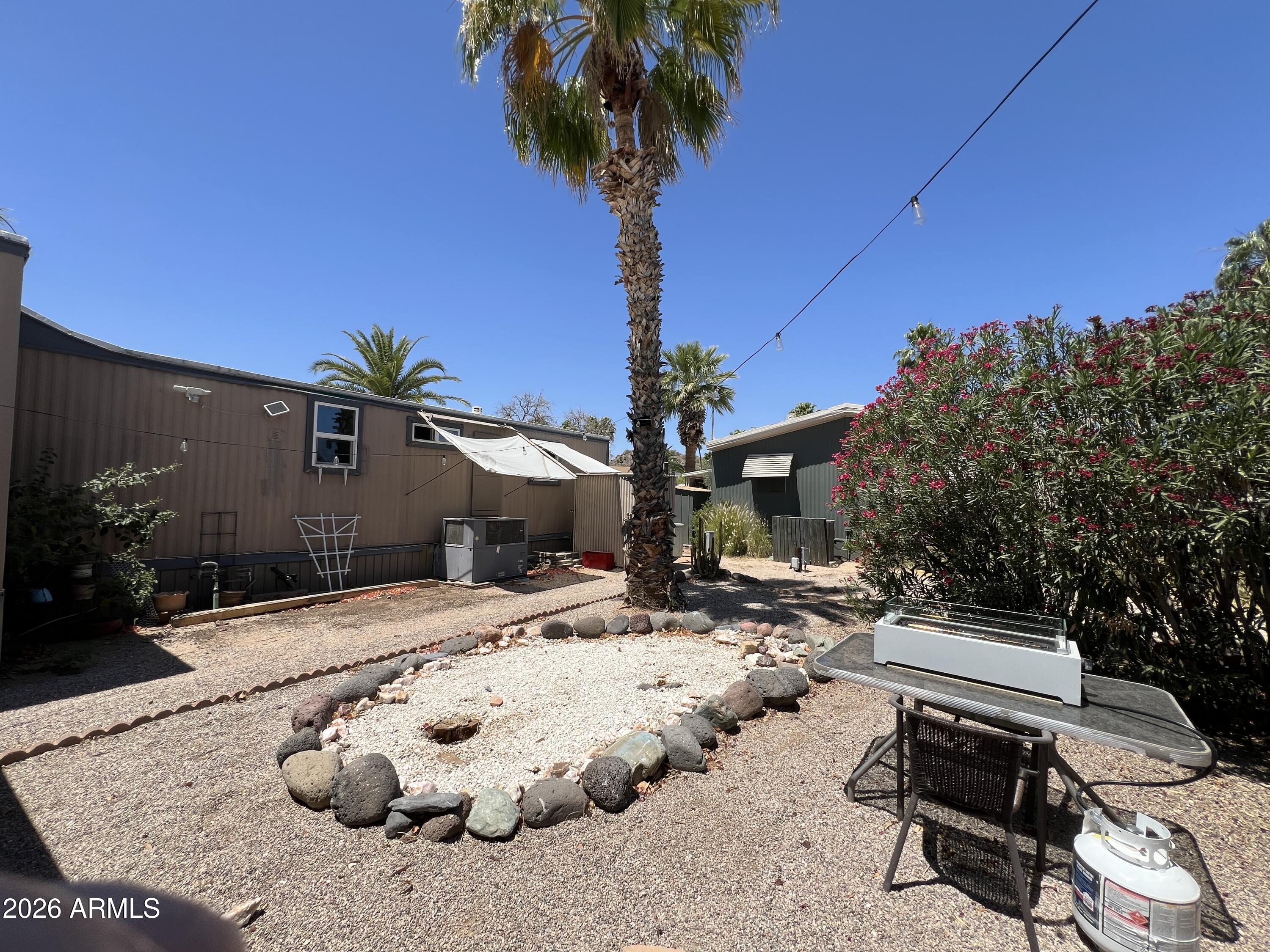 19225 North Cave Creek Road, Unit 40 Phoenix, AZ 85024 - Photo 20 of 21 a backyard of a house with barbeque oven table and chairs